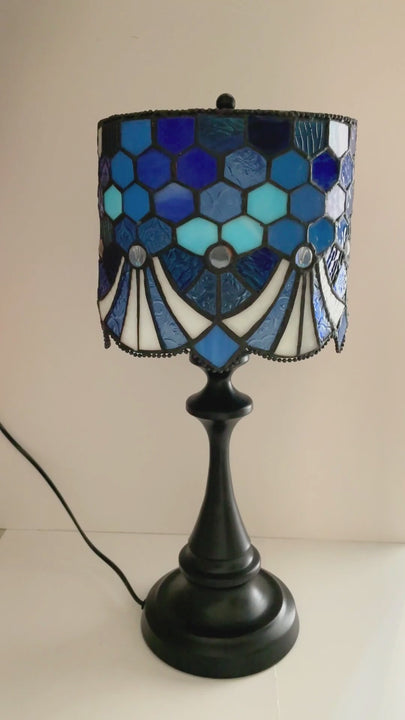Blue stained glass table lamp with handcrafted glass shade and warm vintage style.