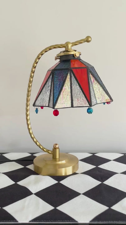 Vintage stained glass table lamp glowing warmly in a cozy bedroom bedside setting